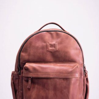 brown leather backpack on white surface