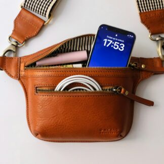 a brown purse with a blue tag