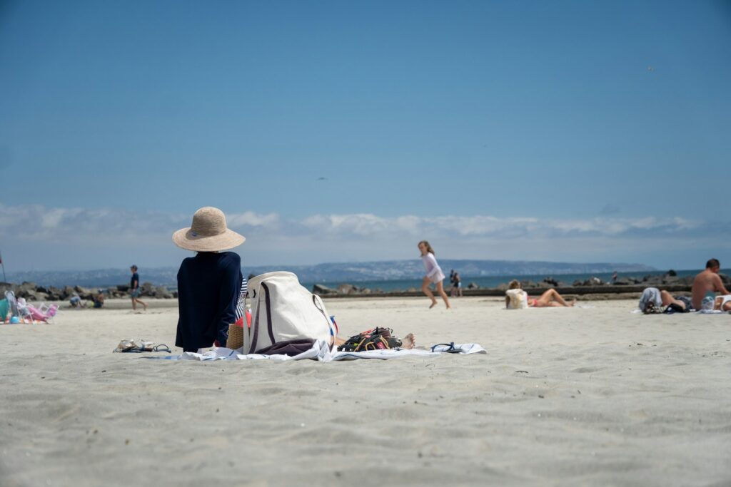People relax and play on a sunny beach.