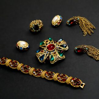a collection of jewelry on a black surface